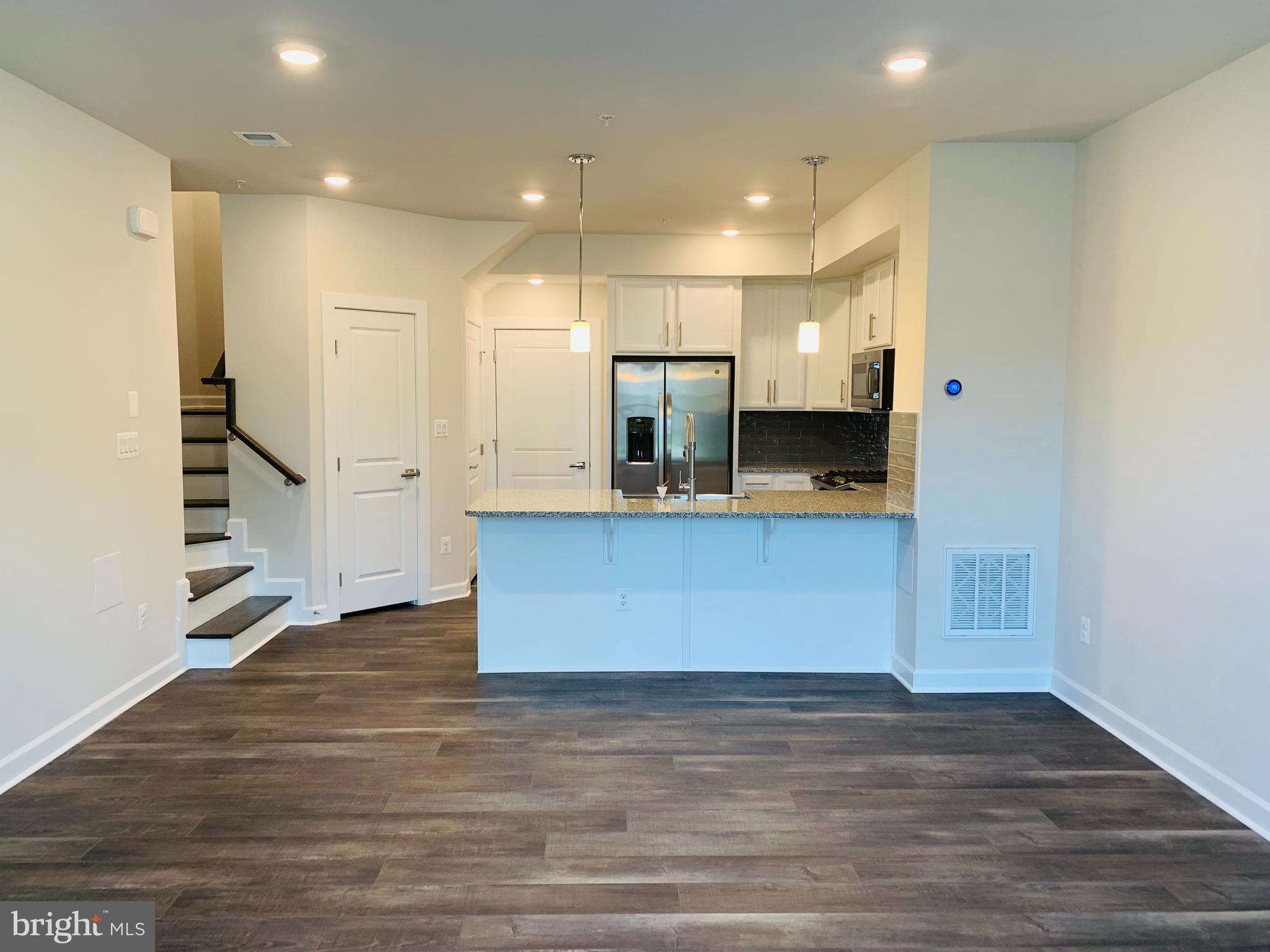 12884 Sunrise Ridge Alley, Unit 47 Herndon, VA 20171 - Photo 3 of 37 a view of kitchen with kitchen island microwave and stove