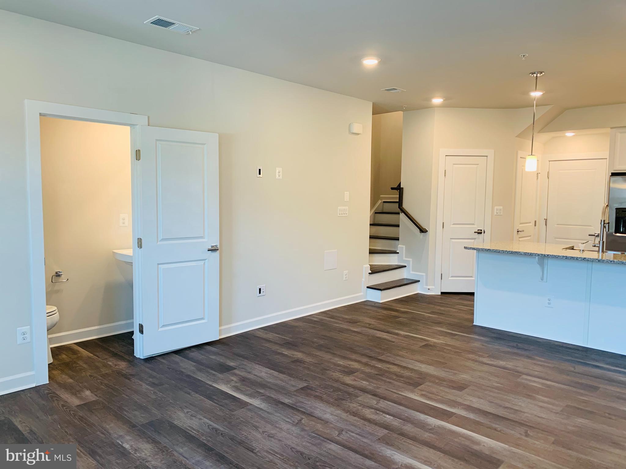 12884 Sunrise Ridge Alley, Unit 47 Herndon, VA 20171 - Photo 4 of 37 a view of a kitchen with wooden floor and stairs