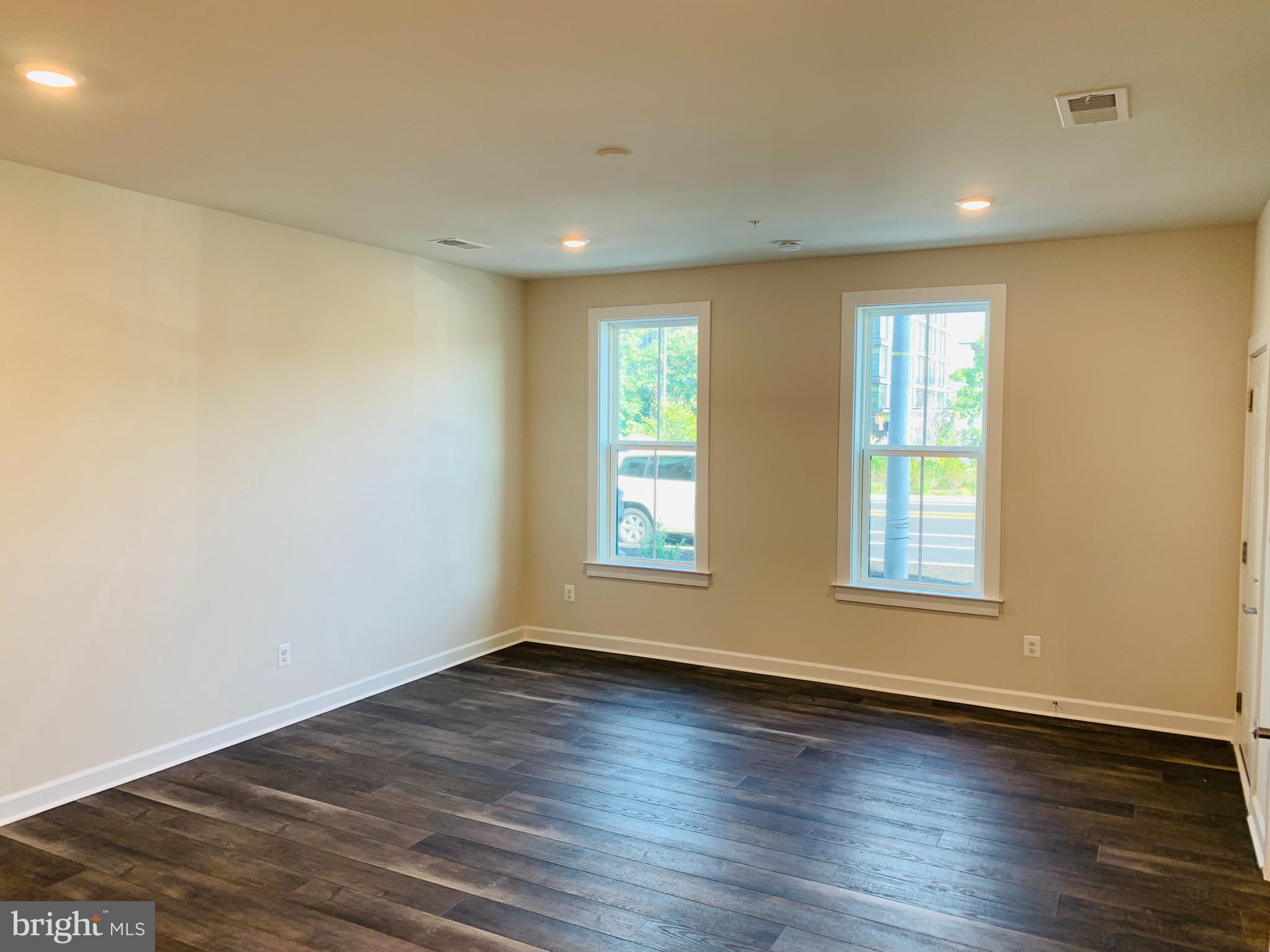 12884 Sunrise Ridge Alley, Unit 47 Herndon, VA 20171 - Photo 5 of 37 an empty room with wooden floor and windows