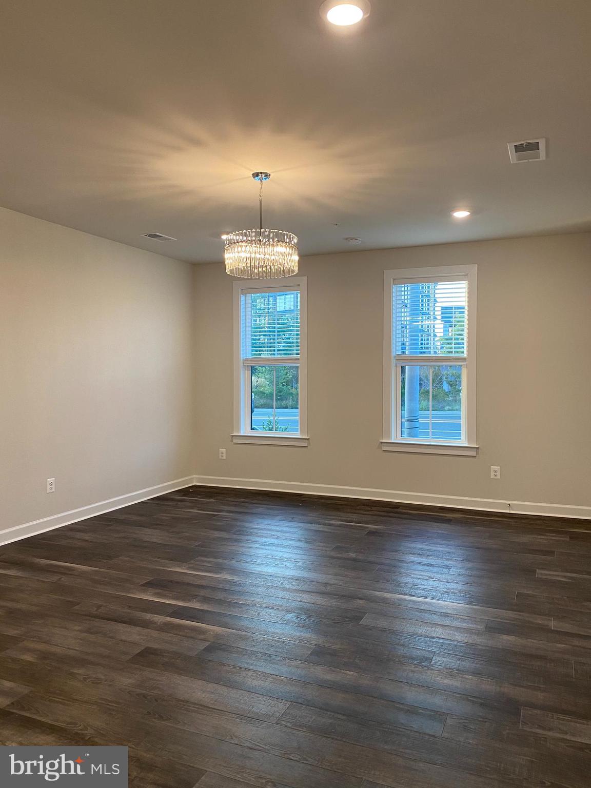 12884 Sunrise Ridge Alley, Unit 47 Herndon, VA 20171 - Photo 6 of 37 an empty room with wooden floor and windows