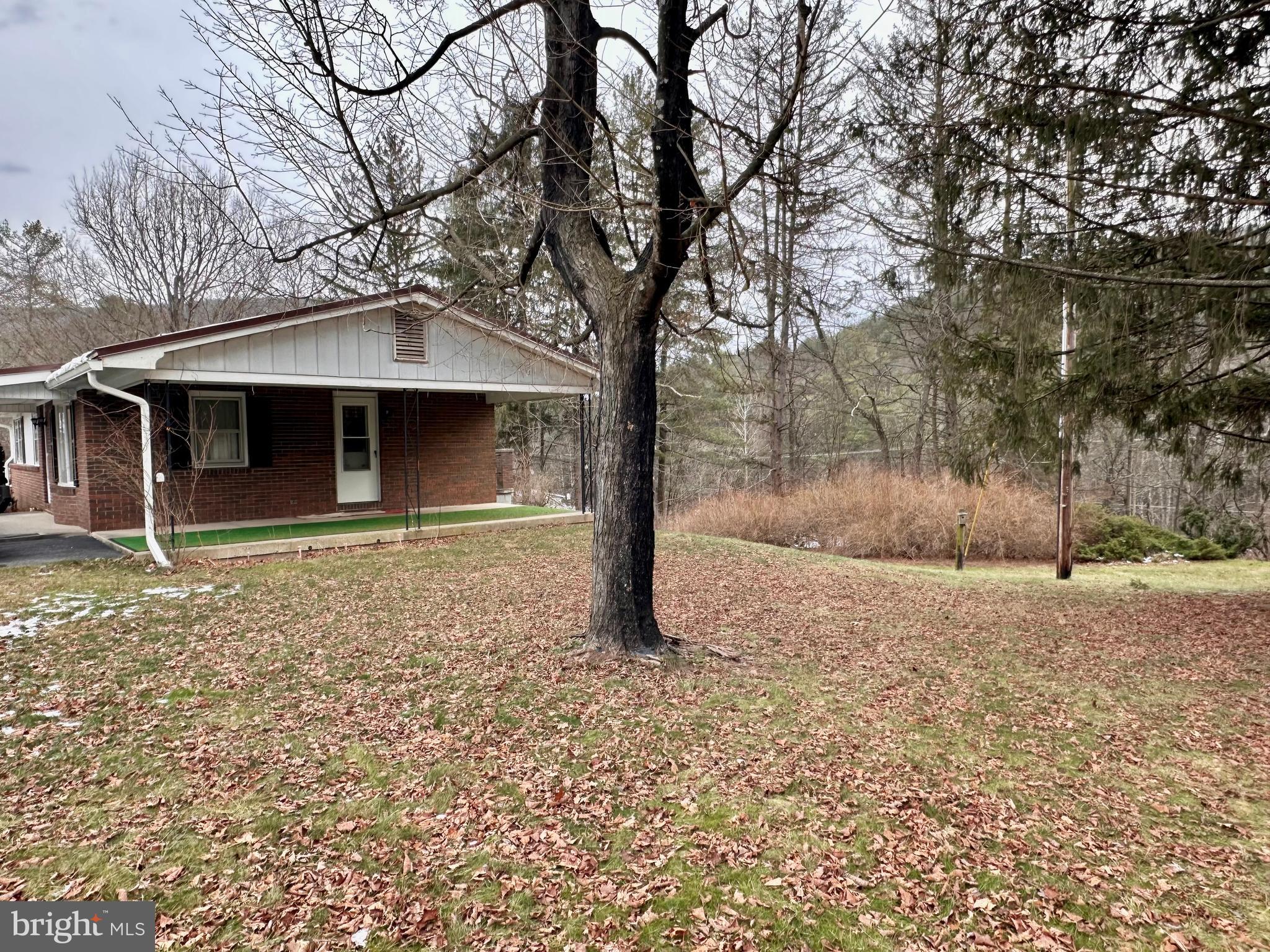 242 Gracey Road Waterfall, PA 16689 - Photo 25 of 40 a front view of a house with garden