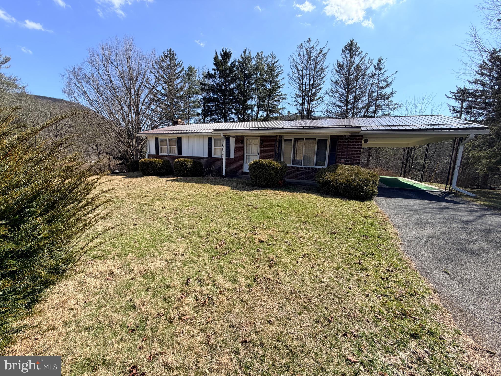 242 Gracey Road Waterfall, PA 16689 - Photo 32 of 40 a front view of a house with yard tree s