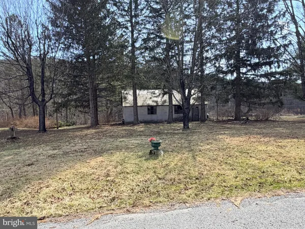 a view of a yard with a house in the background