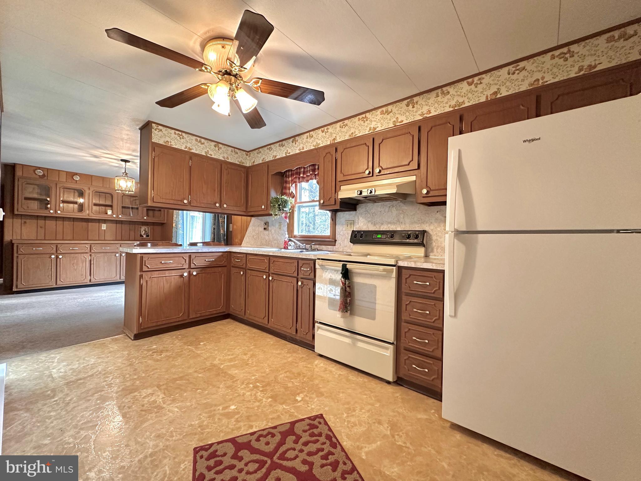 242 Gracey Road Waterfall, PA 16689 - Photo 6 of 40 a kitchen with appliances cabinets and a sink