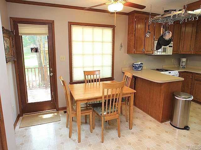 7320 Glendower Road Raleigh, NC 27613 - Photo 7 of 12 Large breakfast nook with door out to deck.