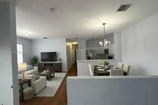 a view of a livingroom with furniture and a flat screen tv