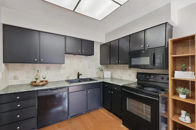 a kitchen with a sink stove and cabinets