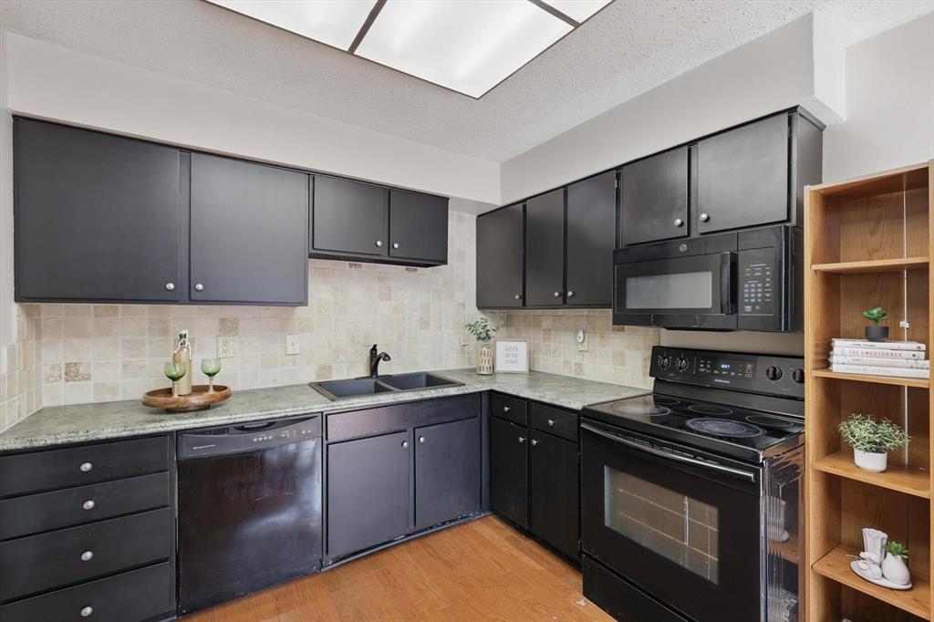 2700 Stonehaven Court Irving, TX 75038 - Photo 12 of 40 a kitchen with a sink stove and cabinets
