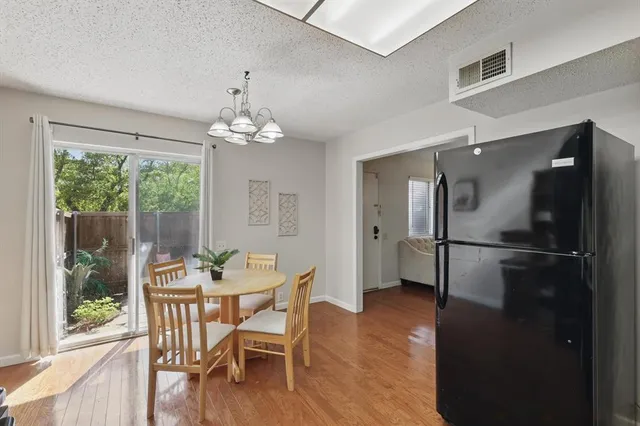 a dining room with furniture window and wooden floor