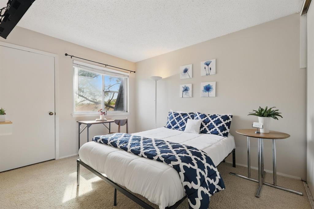 2700 Stonehaven Court Irving, TX 75038 - Photo 19 of 40 a bedroom with a bed and a painting on the wall