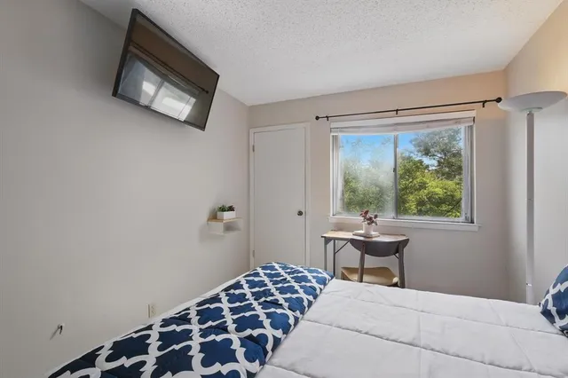 a bedroom with a bed and a window