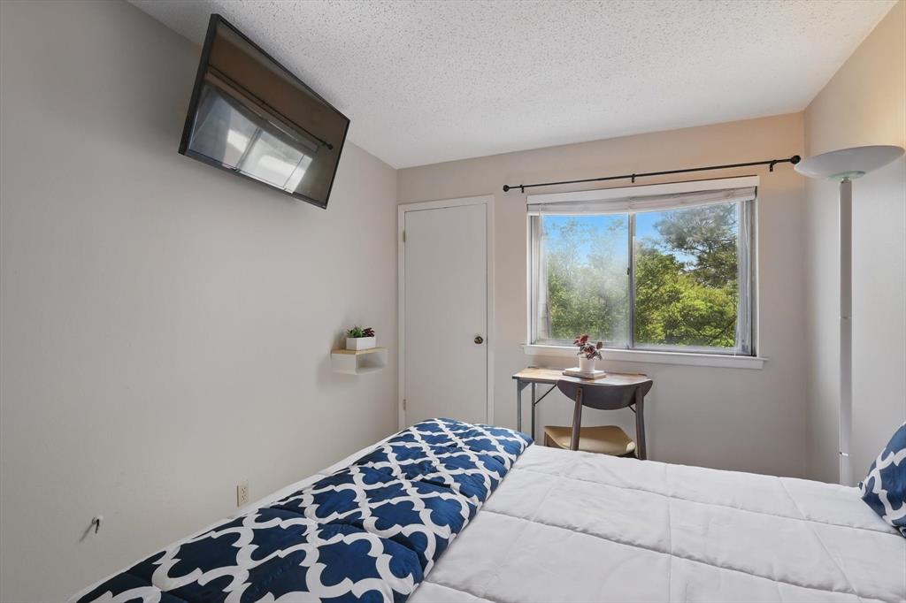 2700 Stonehaven Court Irving, TX 75038 - Photo 20 of 40 a bedroom with a bed and a window