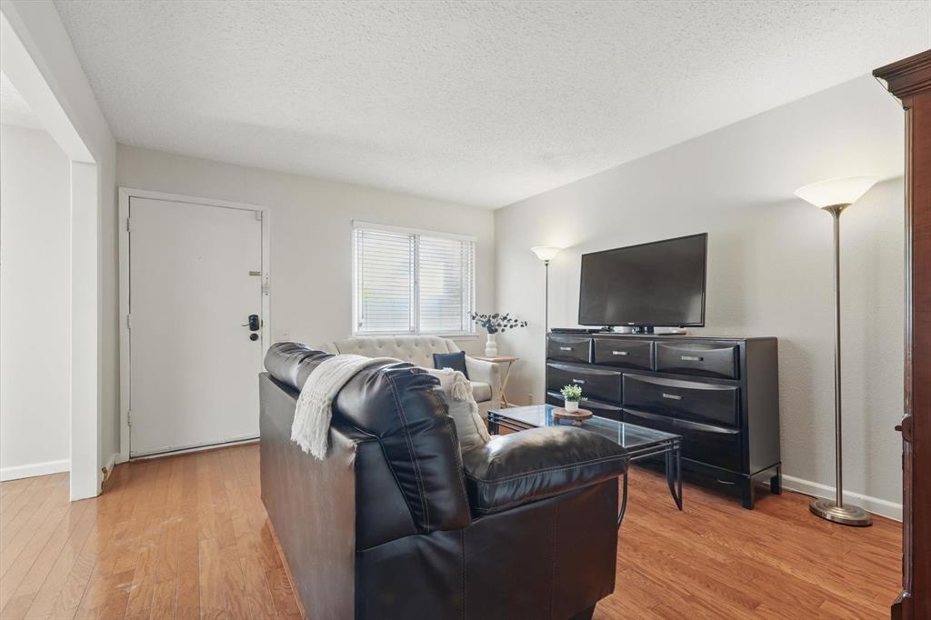 2700 Stonehaven Court Irving, TX 75038 - Photo 2 of 40 a living room with furniture and a flat screen tv