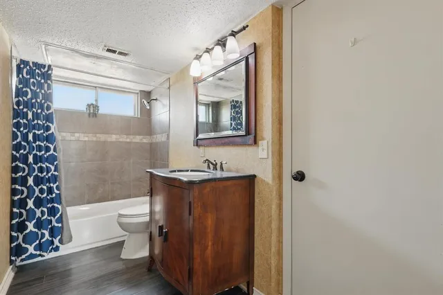 a bathroom with a toilet a sink and bathtub