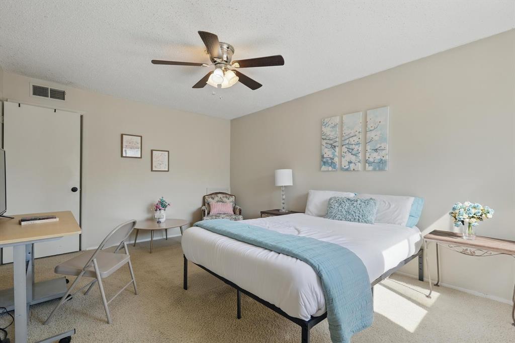 2700 Stonehaven Court Irving, TX 75038 - Photo 28 of 40 a bedroom with a bed and a chandelier