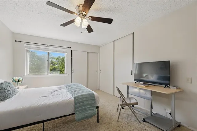a bedroom with a large bed and a flat screen tv