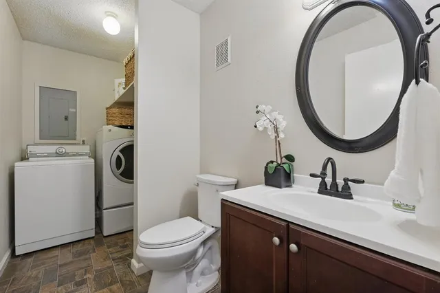 a bathroom with a sink a toilet and a mirror
