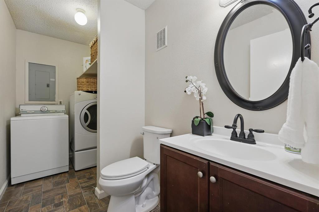 2700 Stonehaven Court Irving, TX 75038 - Photo 31 of 40 a bathroom with a sink a toilet and a mirror