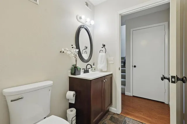 a bathroom with a toilet a sink and mirror