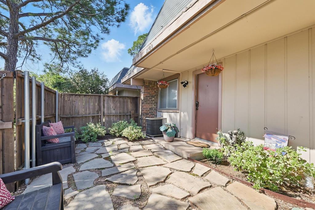 2700 Stonehaven Court Irving, TX 75038 - Photo 35 of 40 a view of a backyard with potted plants and a fountain