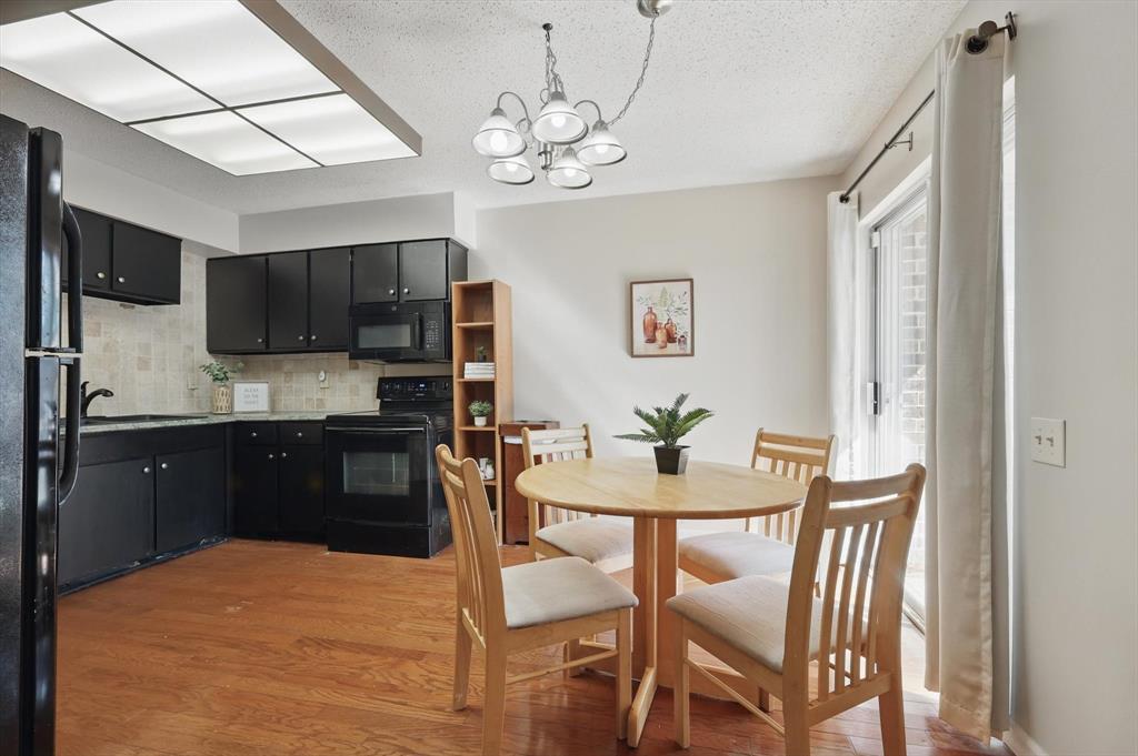 2700 Stonehaven Court Irving, TX 75038 - Photo 9 of 40 a kitchen with stainless steel appliances granite countertop a dining table chairs a refrigerator and a microwave