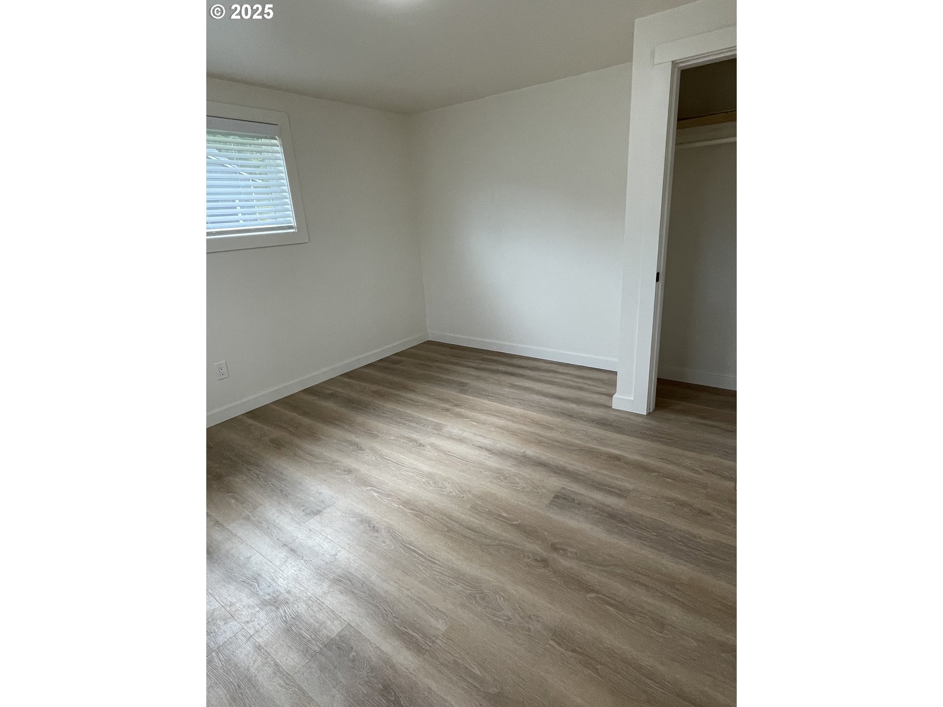 287 East 3rd Street Lowell, OR 97452 - Photo 20 of 23 a view of an empty room with wooden floor and a window