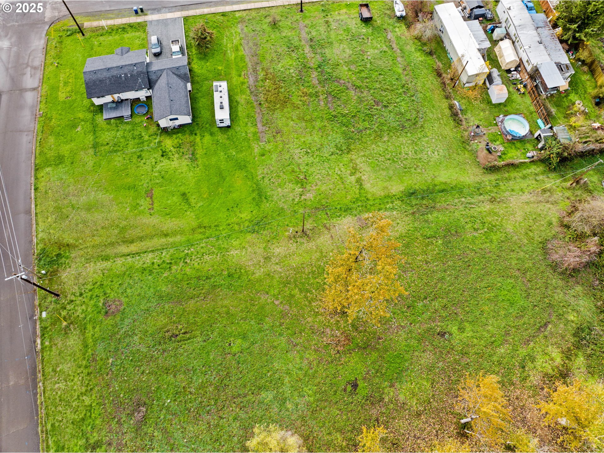 287 East 3rd Street Lowell, OR 97452 - Photo 6 of 23 a backyard of a house with lots of green space