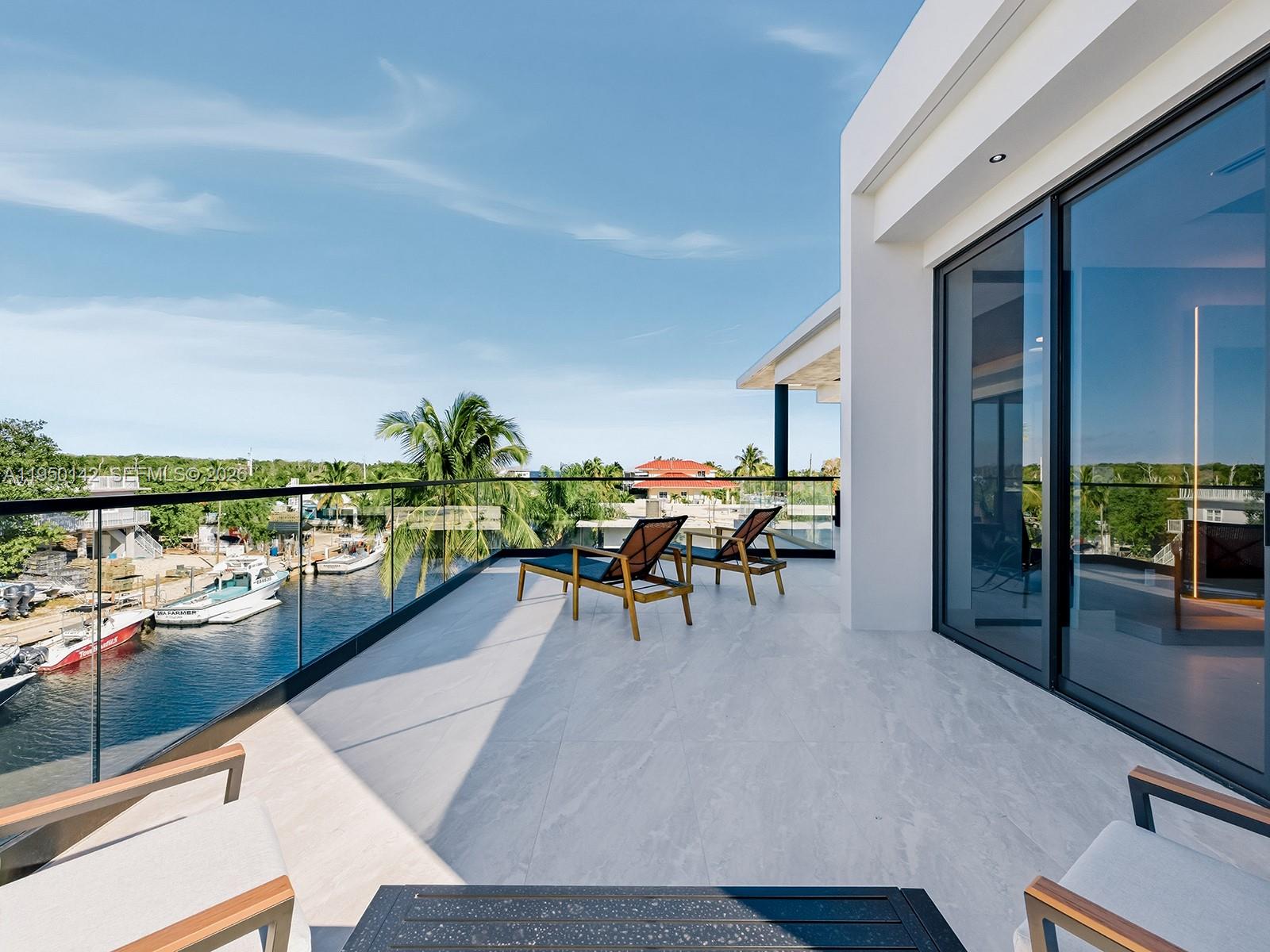 16 South Exuma Road Key Largo, FL 33037 - Photo 16 of 21 a view of a chairs and table on the terrace