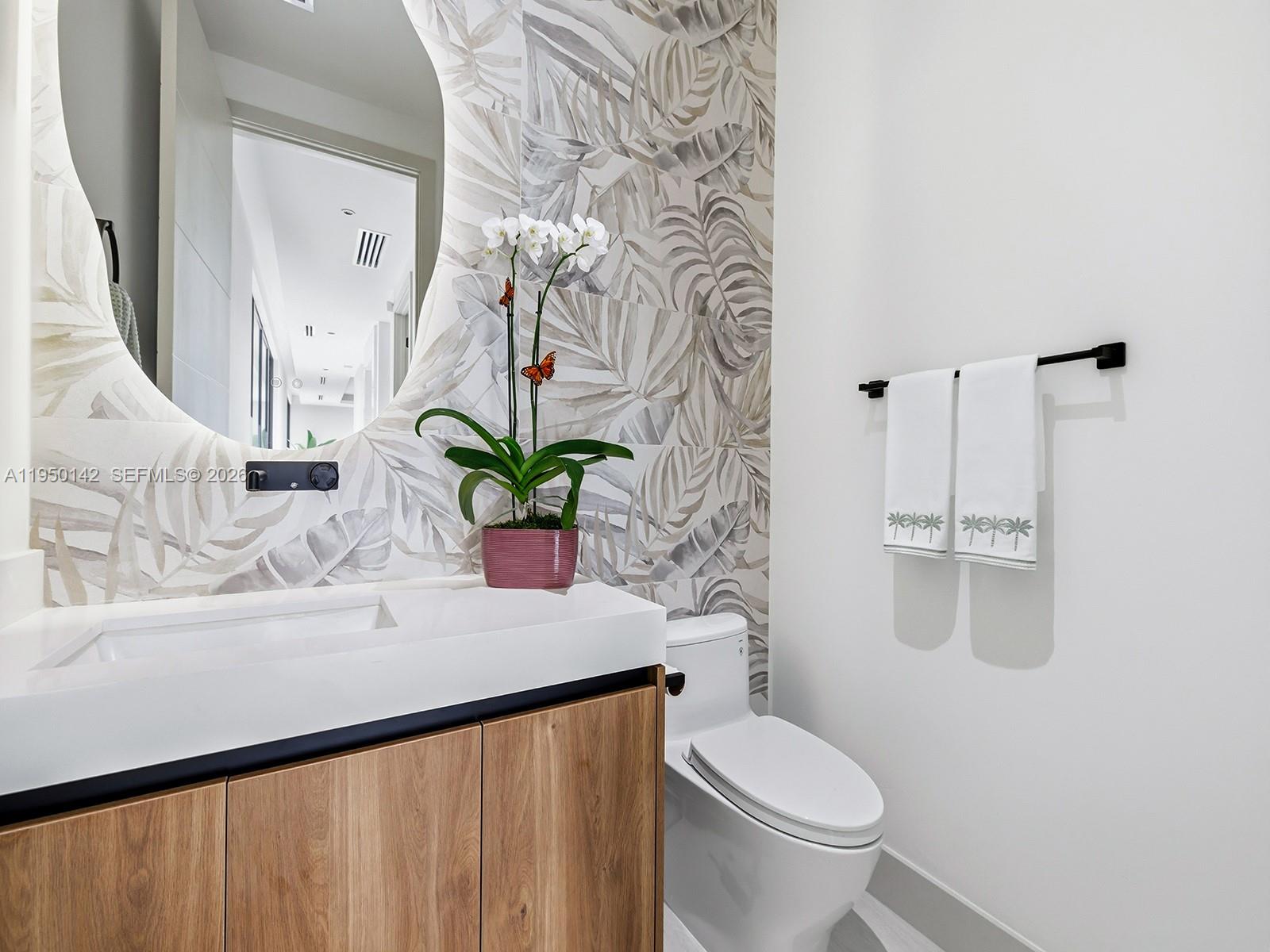 16 South Exuma Road Key Largo, FL 33037 - Photo 10 of 21 a bathroom with a sink a toilet and a mirror