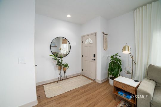 925 West Coronado Avenue Ridgecrest, CA 93555 - Photo 8 of 33 a view of a hallway with wooden floor and a potted plant