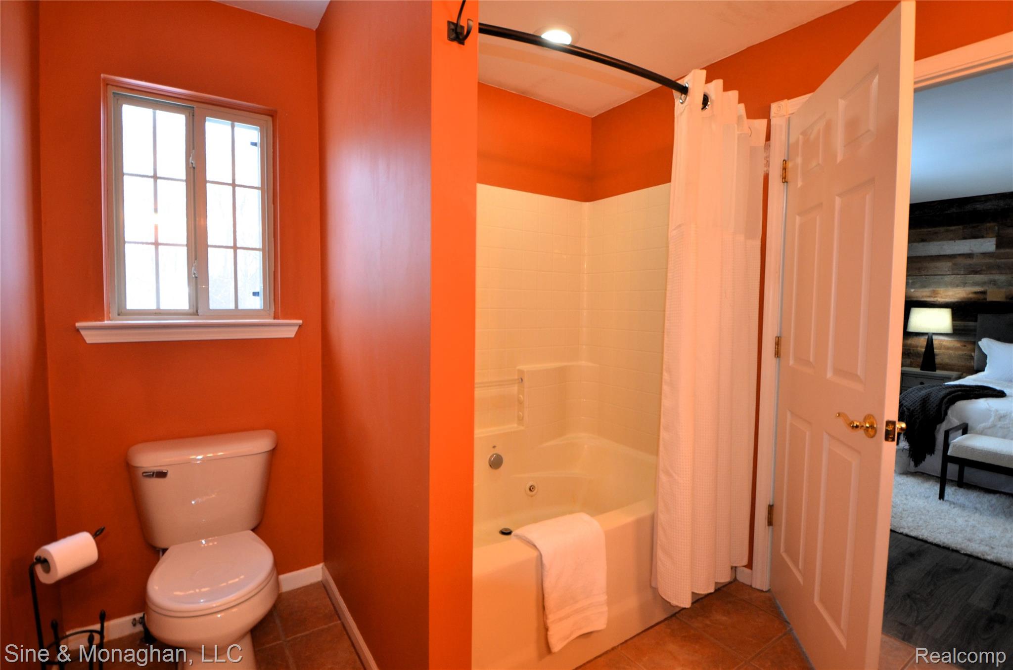76152 Burman Road Richmond, MI 48062 - Photo 44 of 75 Ensuite bathroom with shower / bath combo with shower curtain and tile patterned floors