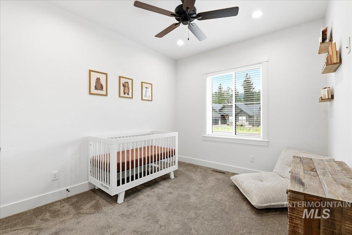 13152 Hawks Bay Road Donnelly, ID 83615 - Photo 17 of 29 Room featuring recessed lighting, a ceiling fan, a window with horizontal blinds, and neutral carpet flooring