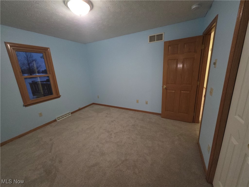 2291 Armstrong Road Wooster, OH 44691 - Photo 5 of 23 Bedroom with a textured ceiling, carpet flooring, and a smoke detector