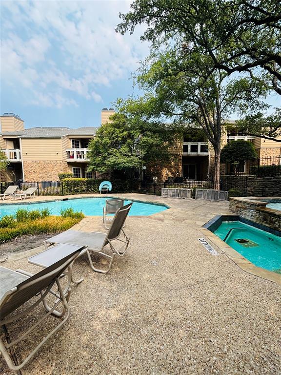 14277 Preston Road, Unit 416 Dallas, TX 75254 - Photo 13 of 40 Expansive outdoor area featuring a swimming pool, integrated spa, and exposed aggregate concrete decking