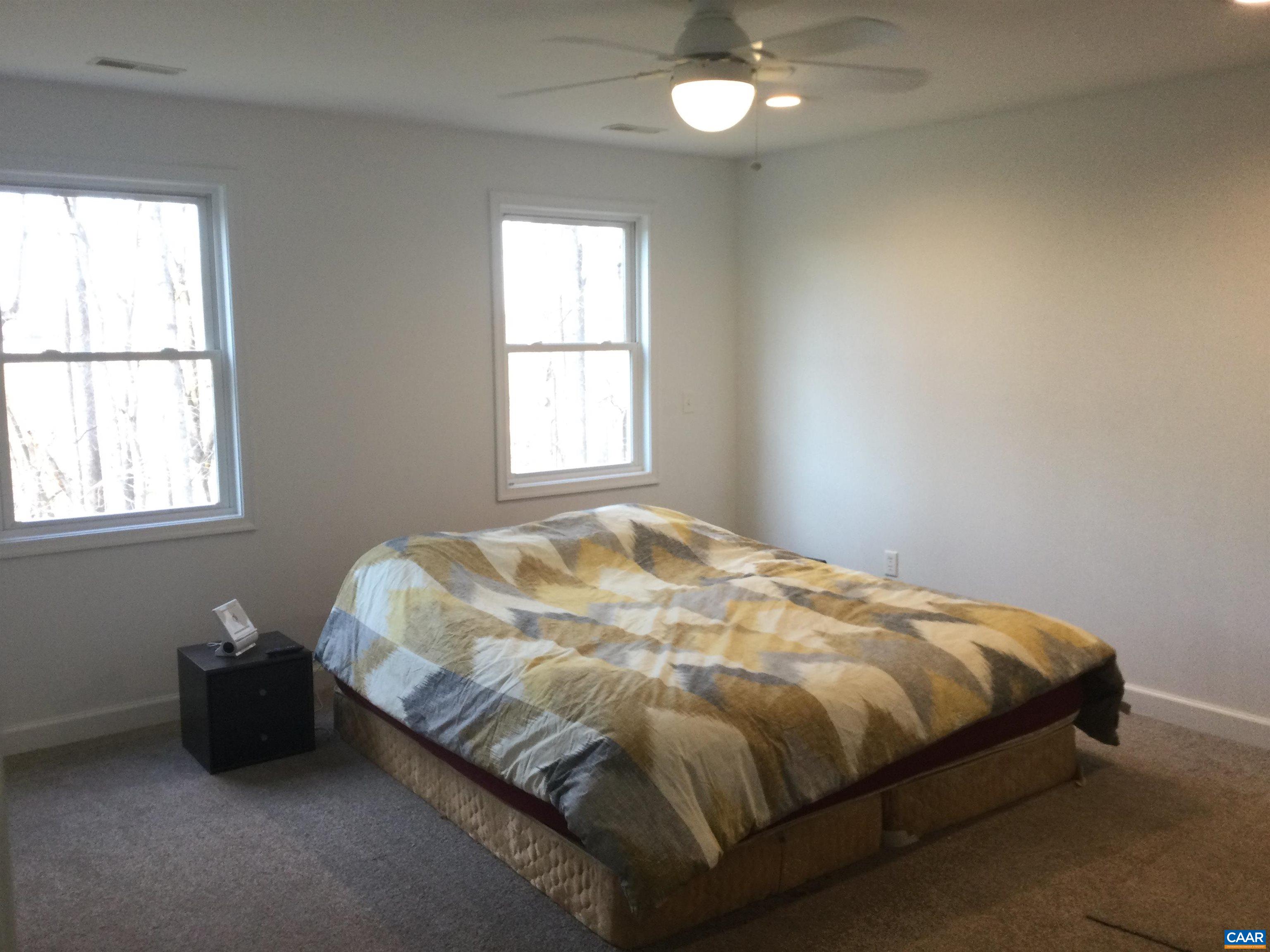 5211 Fredericksburg Road Ruckersville, VA 22968 - Photo 23 of 33 a bed sitting in a bedroom next to a window