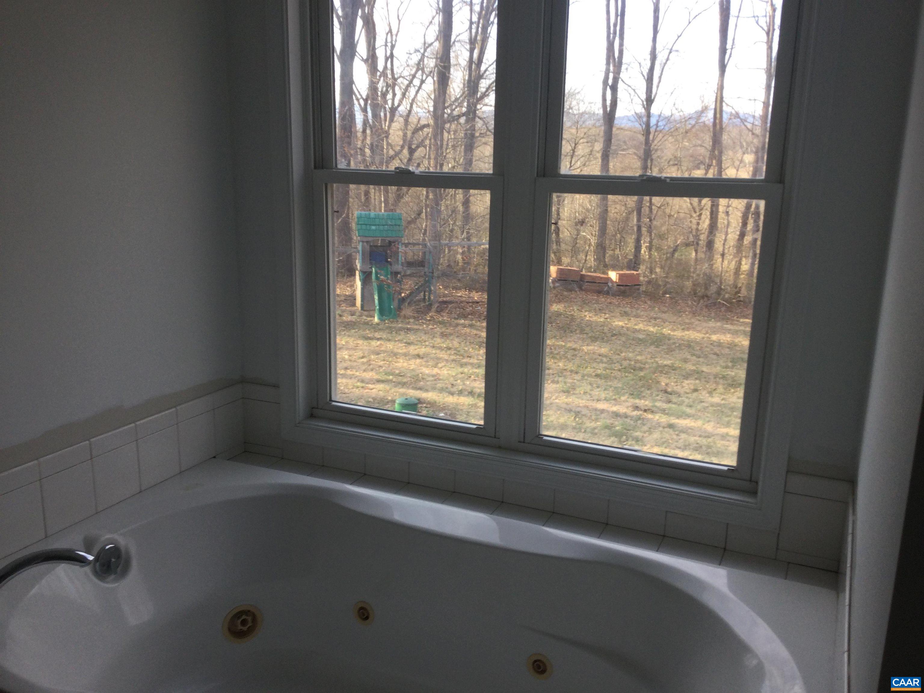 5211 Fredericksburg Road Ruckersville, VA 22968 - Photo 24 of 33 a white bath tub sitting next to a window