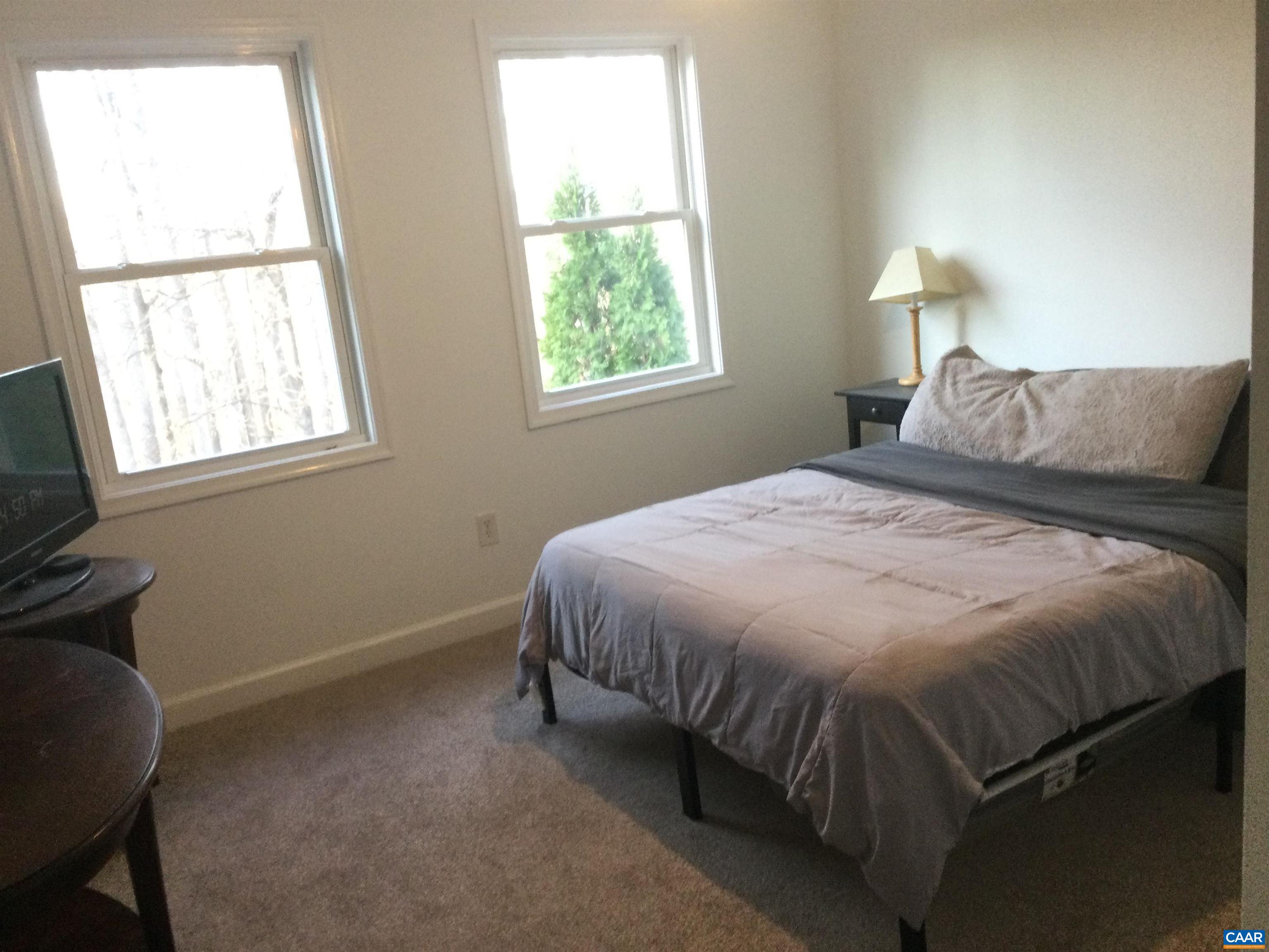 5211 Fredericksburg Road Ruckersville, VA 22968 - Photo 25 of 33 a bed sitting in a bedroom next to a window