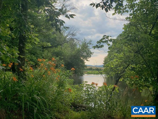 5211 Fredericksburg Road Ruckersville, VA 22968 - Photo 3 of 33 a view of a lake from a yard