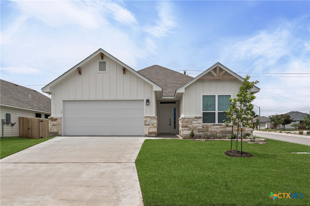a front view of house with yard and green space