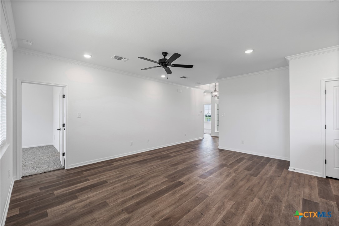 8023 Pineridge Way Temple, TX 76502 - Photo 13 of 28 an empty room with wooden floor and a ceiling fan