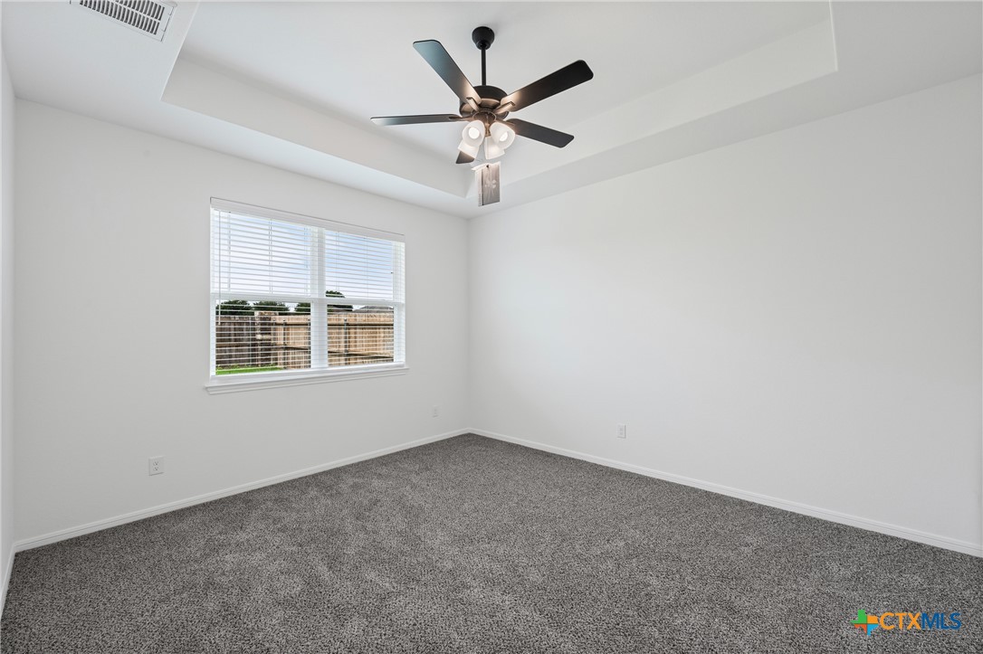 8023 Pineridge Way Temple, TX 76502 - Photo 22 of 28 an empty room with a ceiling fan and window