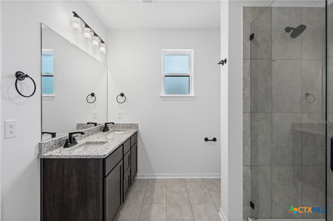 8023 Pineridge Way Temple, TX 76502 - Photo 25 of 28 a bathroom with a double vanity sink and mirror