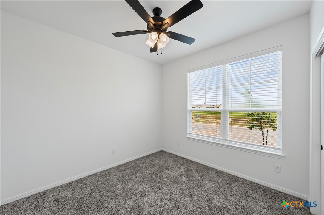 8023 Pineridge Way Temple, TX 76502 - Photo 6 of 28 an empty room with a window and a ceiling fan