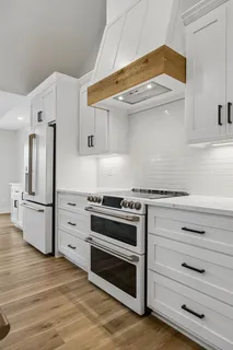 a kitchen with stainless steel appliances granite countertop a stove and a refrigerator