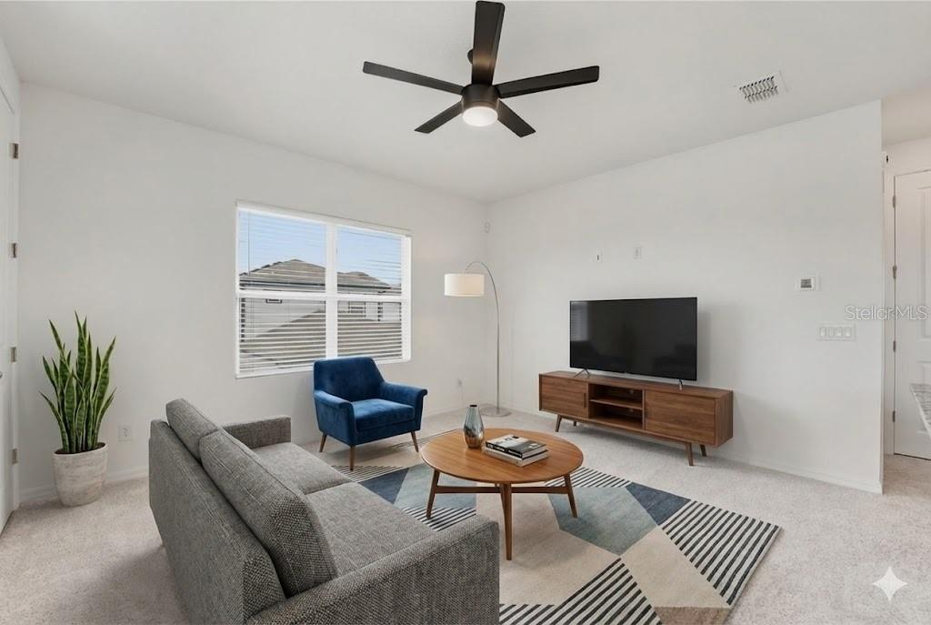 6552 Barnstorm Way St. Cloud, FL 34771 - Photo 11 of 17 a living room with furniture and a flat screen tv