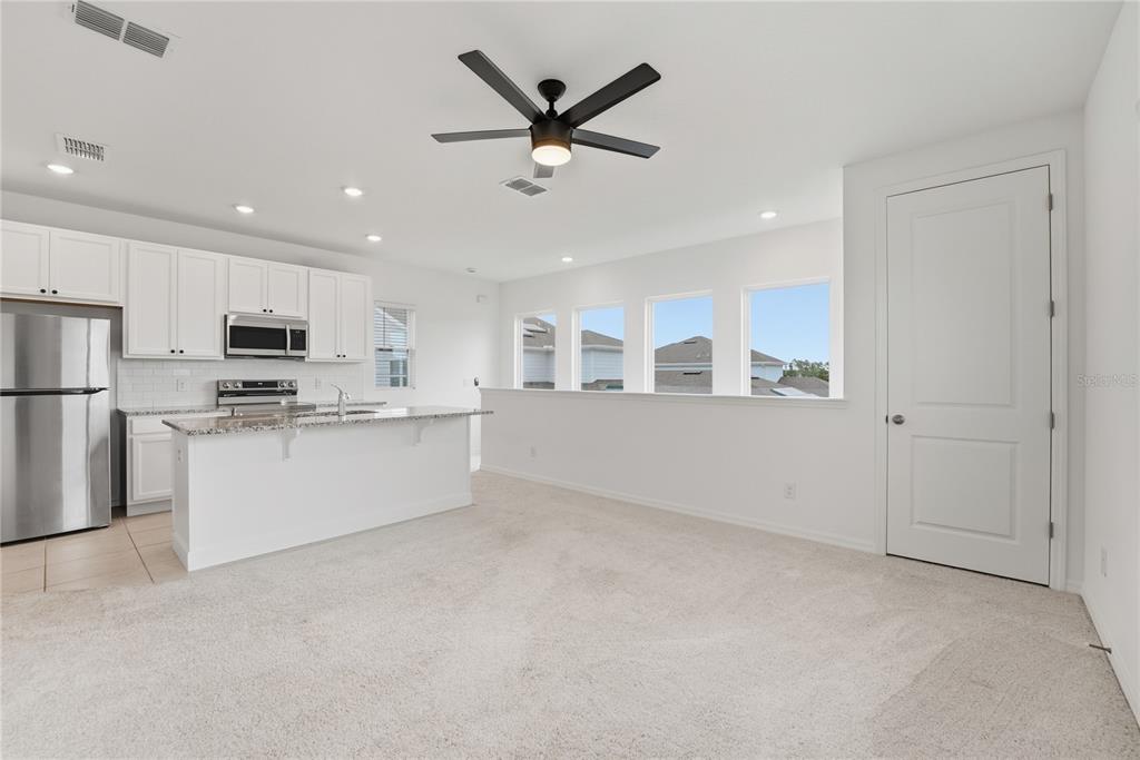 6552 Barnstorm Way St. Cloud, FL 34771 - Photo 13 of 17 a view of kitchen with sink microwave and refrigerator