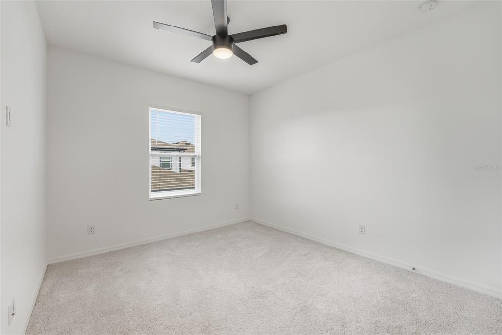 6552 Barnstorm Way St. Cloud, FL 34771 - Photo 15 of 17 an empty room with a window and a fan