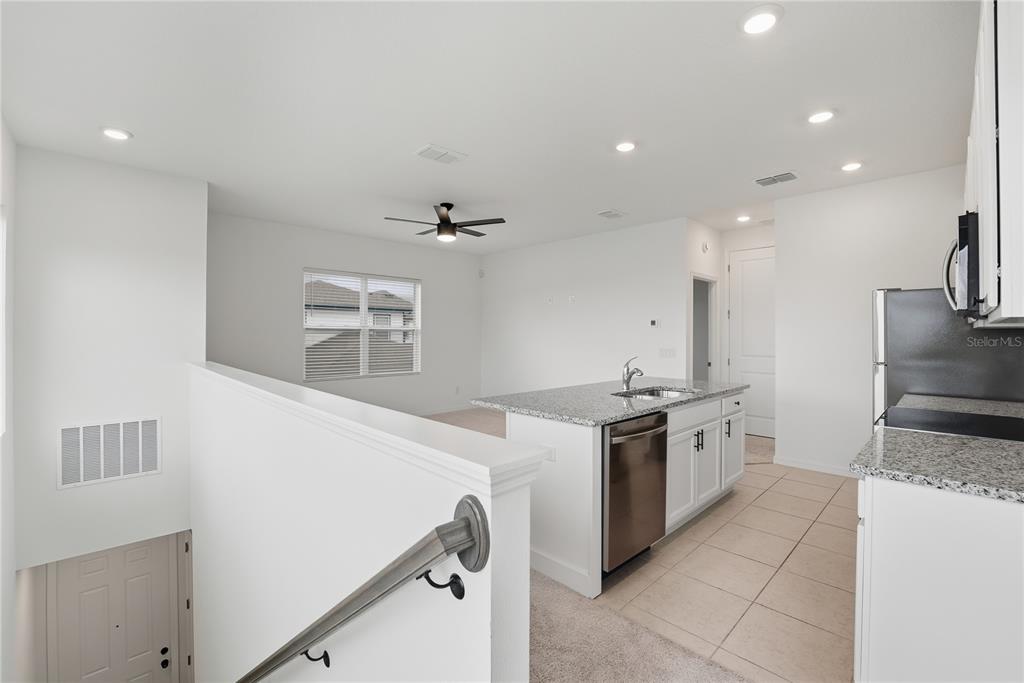 6552 Barnstorm Way St. Cloud, FL 34771 - Photo 2 of 17 a kitchen with stainless steel appliances granite countertop a sink and a stove