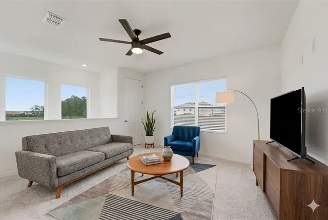 a living room with furniture and a flat screen tv