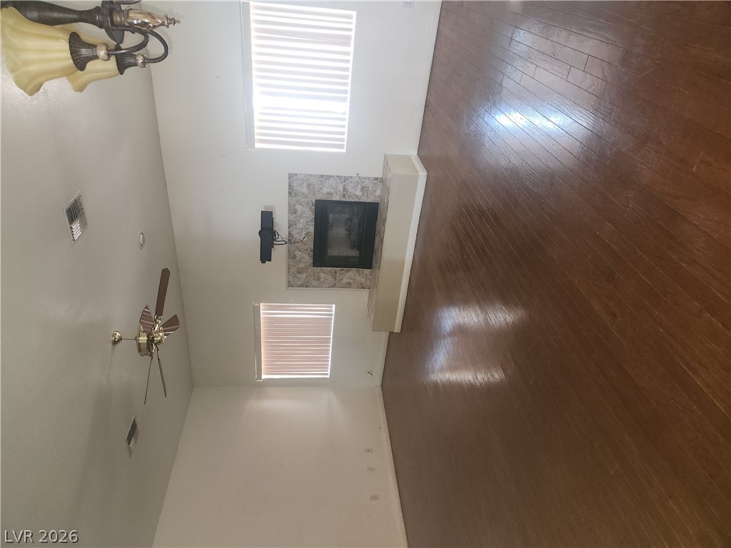 564 Ridgeway Road Henderson, NV 89015 - Photo 5 of 22 A living space featuring rich hardwood flooring and a stylish fireplace for cozy gatherings.